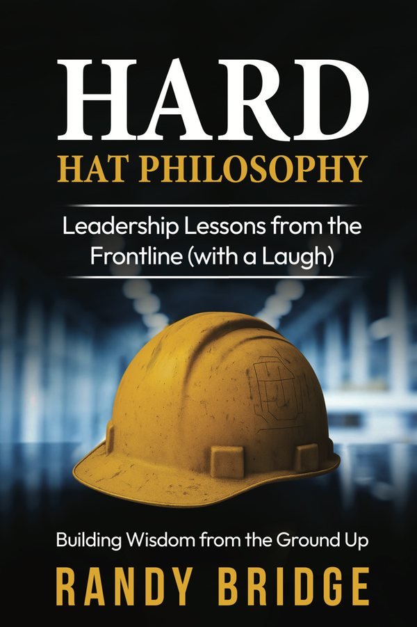 Front cover of Hard Hat Philosophy: Building Wisdom from the Ground Up by Randy Bridge — a worn gold hard hat photographed in a dim industrial corridor.
